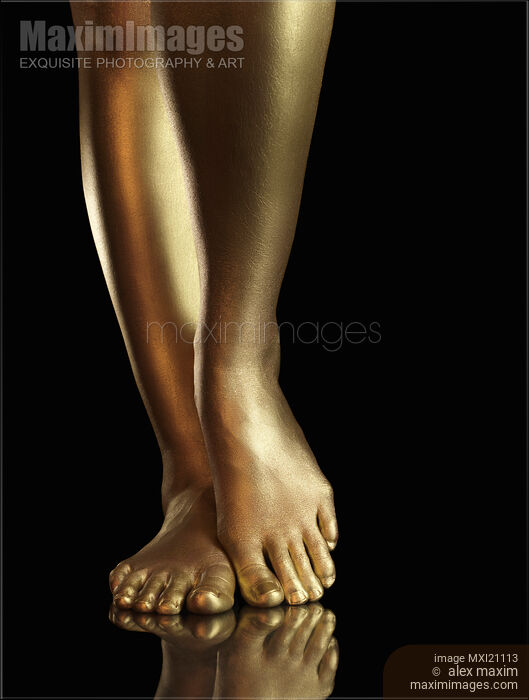 Stock photo of Woman Golden Legs and Feet Closeup Buy commercial use license at MaximImages