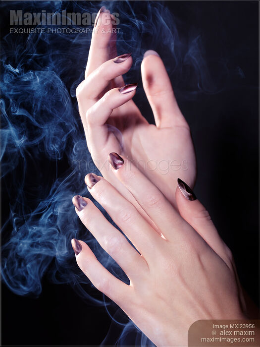 Stock photo of Woman Hands in a Cloud of Smoke Buy commercial use license at MaximImages