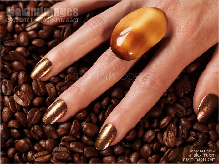 Stock photo of Woman Hands in Coffee Beans Buy commercial use license at MaximImages