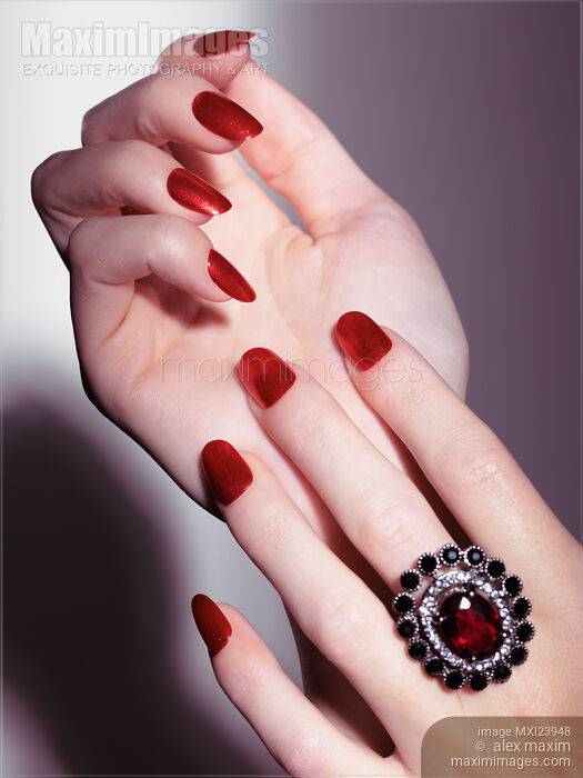 Stock photo of Woman hands with red nail polish and a ring Buy commercial use license at MaximImages
