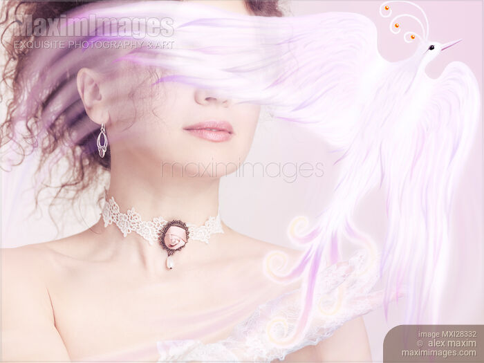 Stock photo of Woman holding a glowing magical bird in her hand Buy commercial use license at MaximImages
