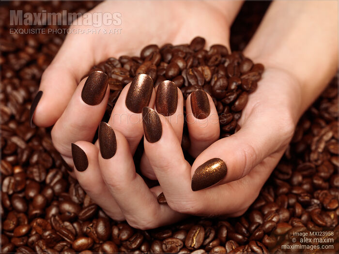 Stock photo of Woman Holding Coffee Beans in Her Hands Buy commercial use license at MaximImages