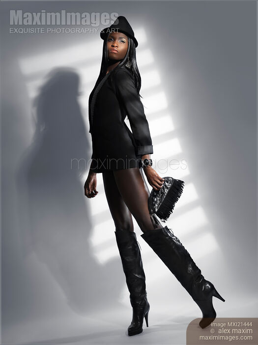 Stock photo of Woman in a Black Jacket and High Boots Buy commercial use license at MaximImages