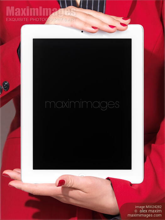 Woman in red business suit holding iPad Stock photo of Woman in red business suit holding iPad Buy commercial use license at MaximImages