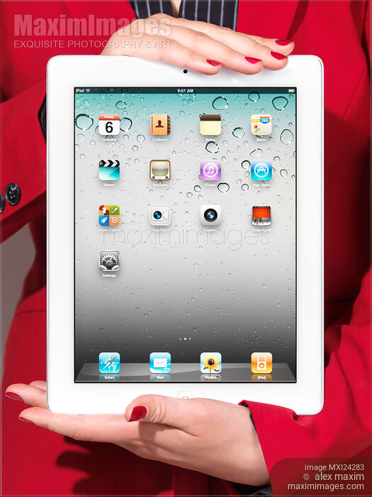 Woman in red business suit holding iPad in her hands Stock photo of Woman in red business suit holding iPad in her hands Buy commercial use license at MaximImages