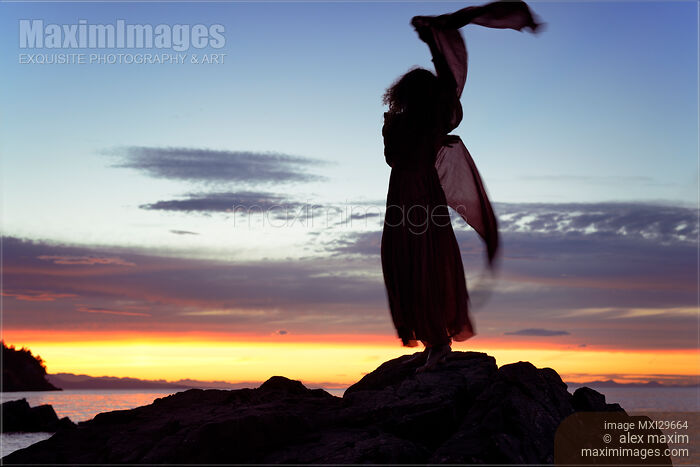 Woman in red dress flying in the wind dancing silhouette in sunset nature scenery Stock photo of Woman in red dress flying in the wind dancing silhouette in sunset nature scenery Buy commercial use license at MaximImages