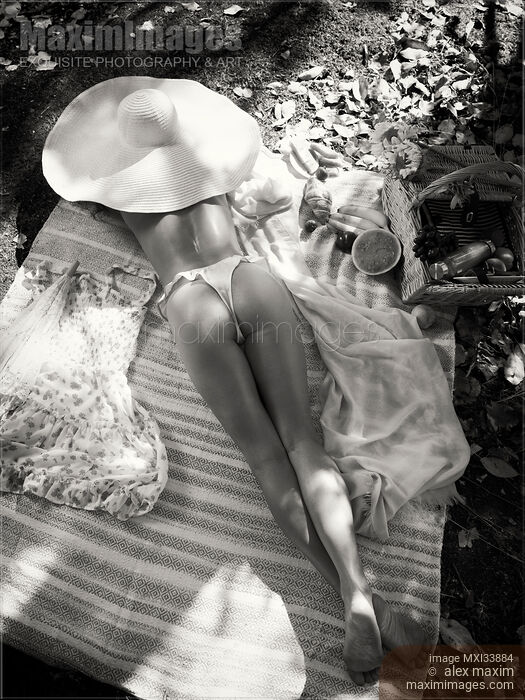 Woman in sun hat and underwear relaxing topless at summer picnic view on her sexy buttocks and long legs. Black and white. Stock photo of Woman in sun hat and underwear relaxing topless at summer picnic view on her sexy buttocks and long legs. Black and white. Buy commercial use license at MaximImages