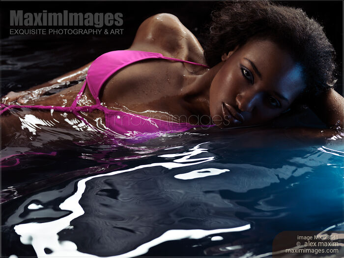 Woman in Swimsuit Lying in Water Stock photo of Woman in Swimsuit Lying in Water Buy commercial use license at MaximImages