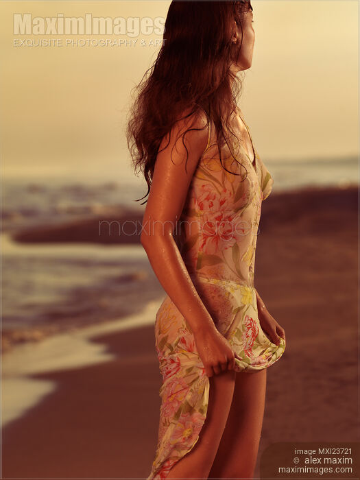 Woman in Wet Dress at the Beach Stock photo of Woman in Wet Dress at the Beach Buy commercial use license at MaximImages