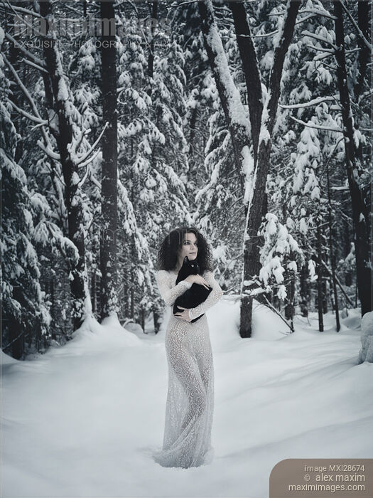 Woman in white dress walking in snow with a black cat in her hands Stock photo of Woman in white dress walking in snow with a black cat in her hands Buy commercial use license at MaximImages