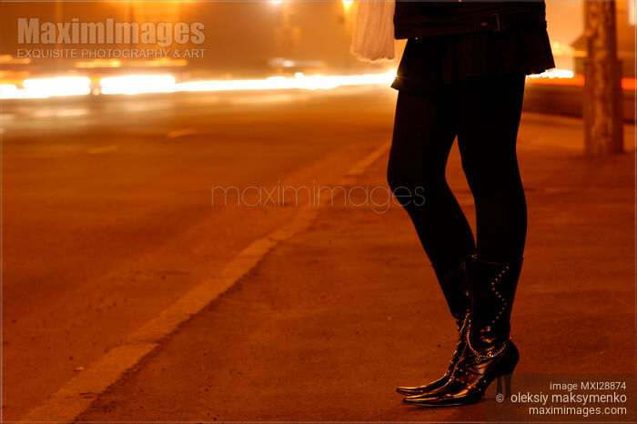 Woman Legs at Night on the Road Stock photo of Woman Legs at Night on the Road Buy commercial use license at MaximImages