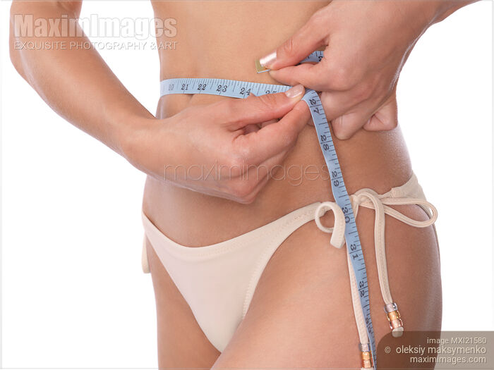 Woman Measuring Her Waist Stock photo of Woman Measuring Her Waist Buy commercial use license at MaximImages