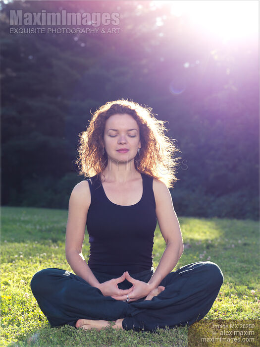 Woman meditating in the nature Stock photo of Woman meditating in the nature Buy commercial use license at MaximImages