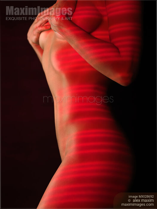 Woman naked body with red laser stripes on skin Stock photo of Woman naked body with red laser stripes on skin Buy commercial use license at MaximImages