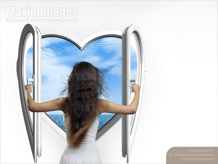 Stock photo of Woman Opening a Heart Shaped Window Buy commercial use license at MaximImages
