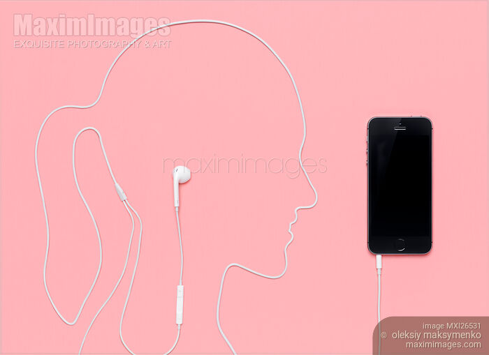 Stock photo of Woman silhouette with headphones plugged into iPhone Buy commercial use license at MaximImages
