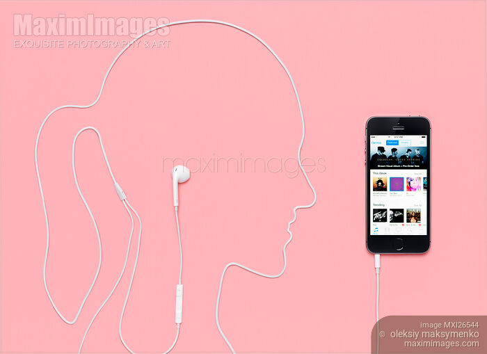Stock photo of Woman silhouette with iPhone headphones iTunes music concept Buy commercial use license at MaximImages