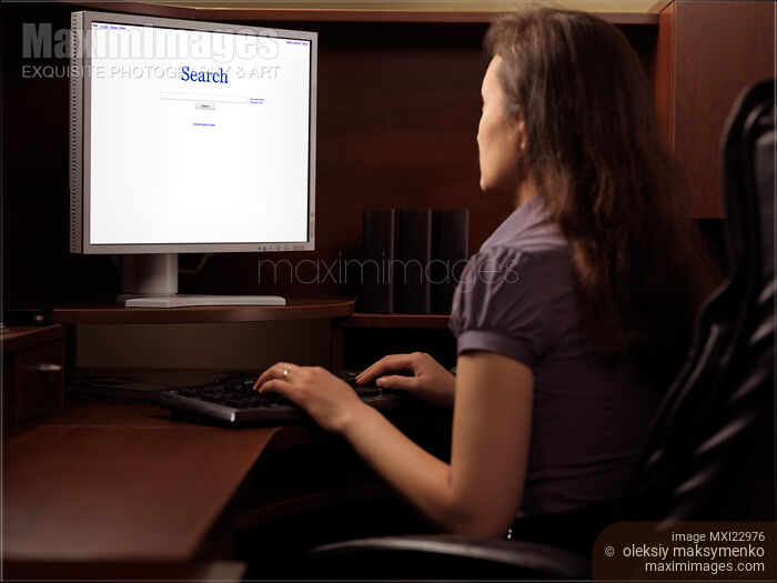 Woman Sitting in Front of a Computer Stock photo of Woman Sitting in Front of a Computer Buy commercial use license at MaximImages