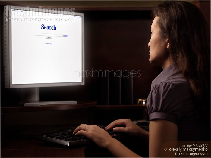 Woman Sitting in Front of a Computer Stock photo of Woman Sitting in Front of a Computer Buy commercial use license at MaximImages