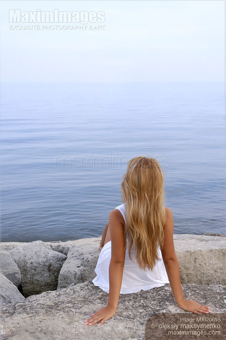 Stock photo of Woman Sitting on a Shore Buy commercial use license at MaximImages