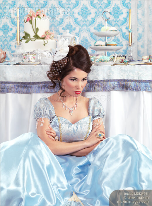 Woman sitting pouting beside a party table Stock photo of Woman sitting pouting beside a party table Buy commercial use license at MaximImages