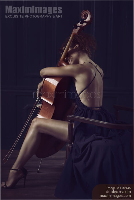Woman sitting thoughtfully with her arms around a cello in elegant dress revealing her sexy legs and back Stock photo of Woman sitting thoughtfully with her arms around a cello in elegant dress revealing her sexy legs and back Buy commercial use license at MaximImages