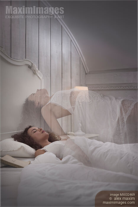 Stock photo of Woman sleeping in bed lucid dreaming her ethereal body rising above her Buy commercial use license at MaximImages