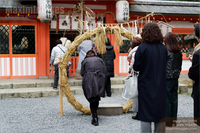 Woman stepping through a straw ring at a Japanese Shinto shrine for purification ritual at Uji-jinja Uji Shrine Stock photo of Woman stepping through a straw ring at a Japanese Shinto shrine for purification ritual at Uji-jinja Uji Shrine Buy commercial use license at MaximImages