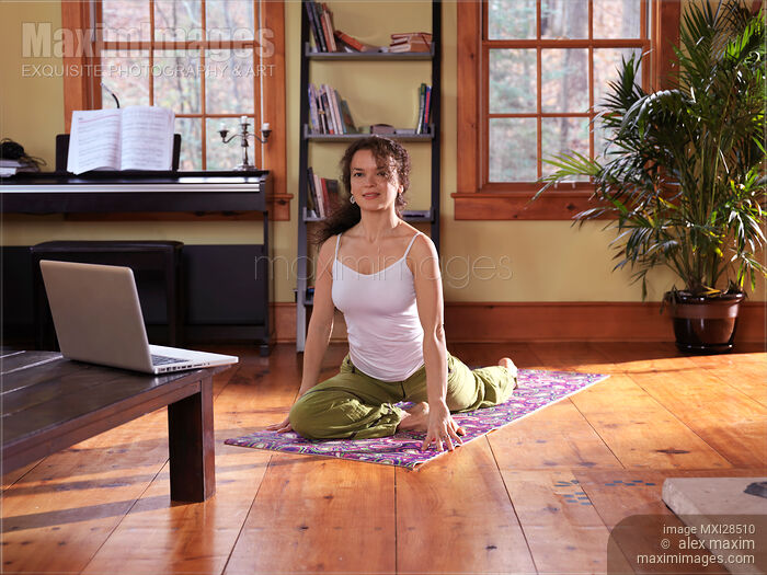 Woman taking a yoga break at home Stock photo of Woman taking a yoga break at home Buy commercial use license at MaximImages
