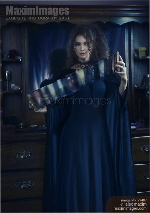 Stock photo of Woman Tarot card reader shuffling cards Buy commercial use license at MaximImages