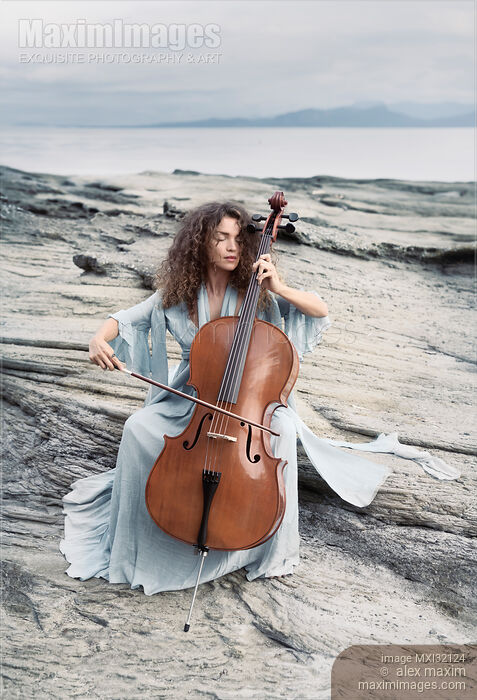 Woman thoughtfully playing cello on an ocean shore in sunrise scenery Stock photo of Woman thoughtfully playing cello on an ocean shore in sunrise scenery Buy commercial use license at MaximImages