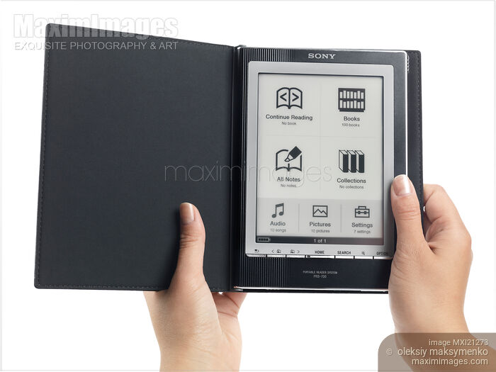 Stock photo of Woman Using Sony Reader Buy commercial use license at MaximImages