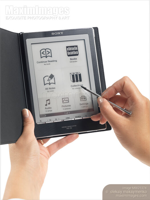 Woman Using Sony Reader Stock photo of Woman Using Sony Reader Buy commercial use license at MaximImages