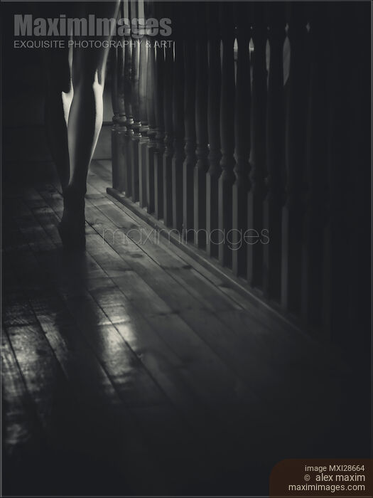 Stock photo of Woman walking barefoot in dark house Closeup of legs Black and white Buy commercial use license at MaximImages