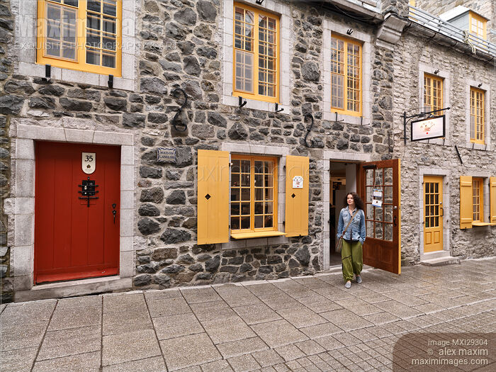 Woman walking out of Amimoc shoe store on Rue de Petit Champlain Street in Old Quebec City Stock photo of Woman walking out of Amimoc shoe store on Rue de Petit Champlain Street in Old Quebec City Buy commercial use license at MaximImages