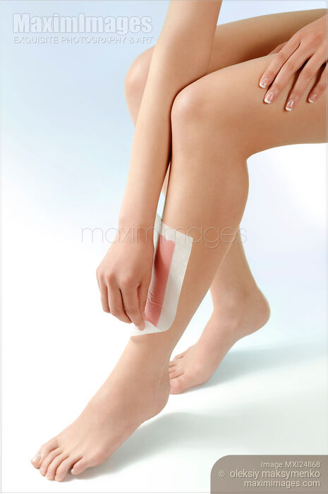 Woman waxing her legs Stock photo of Woman waxing her legs Buy commercial use license at MaximImages