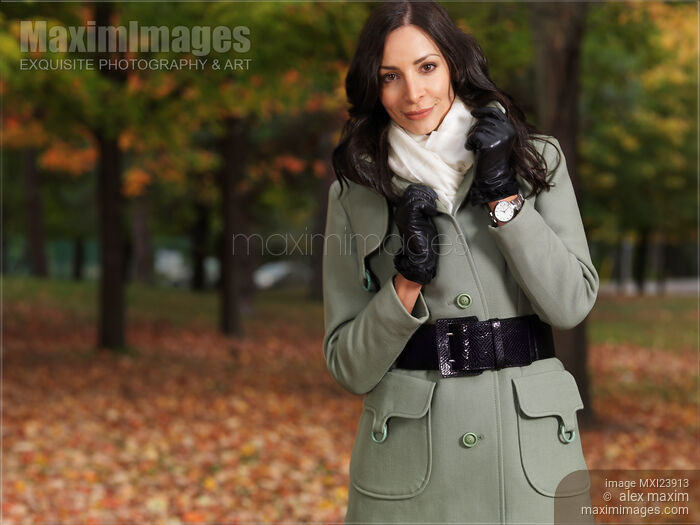 Stock photo of Woman Wearing a Green Coat in Fall Buy commercial use license at MaximImages