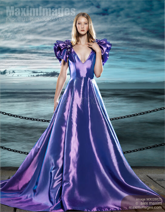 Woman wearing beautiful long blue dress at waterfront Stock photo of Woman wearing beautiful long blue dress at waterfront Buy commercial use license at MaximImages