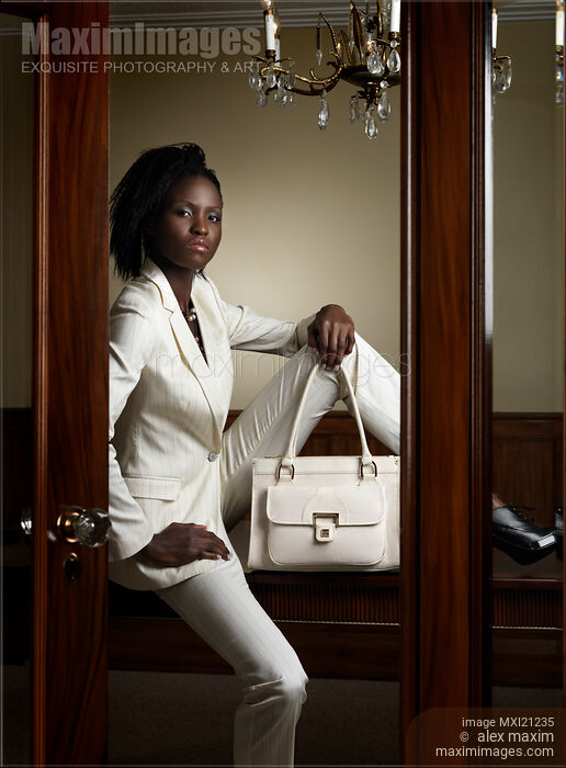 Stock photo of Woman Wearing White Suit Buy commercial use license at MaximImages