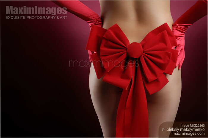 Woman with a Christmas Bow Stock photo of Woman with a Christmas Bow Buy commercial use license at MaximImages