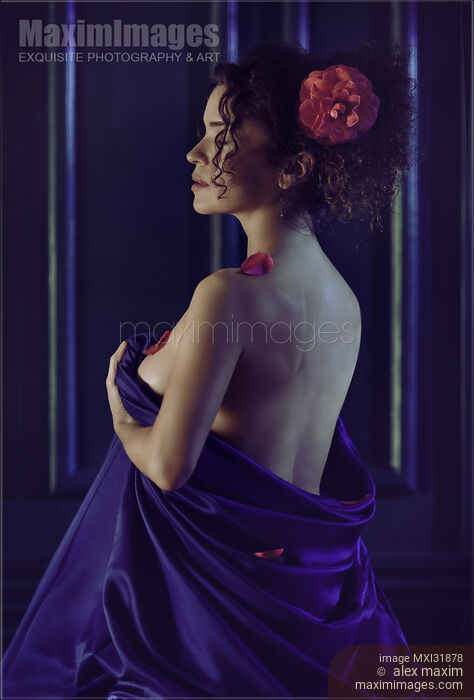 Woman with a flower in her hair sitting with her naked body wrapped in bed sheets revealing bare back Stock photo of Woman with a flower in her hair sitting with her naked body wrapped in bed sheets revealing bare back Buy commercial use license at MaximImages