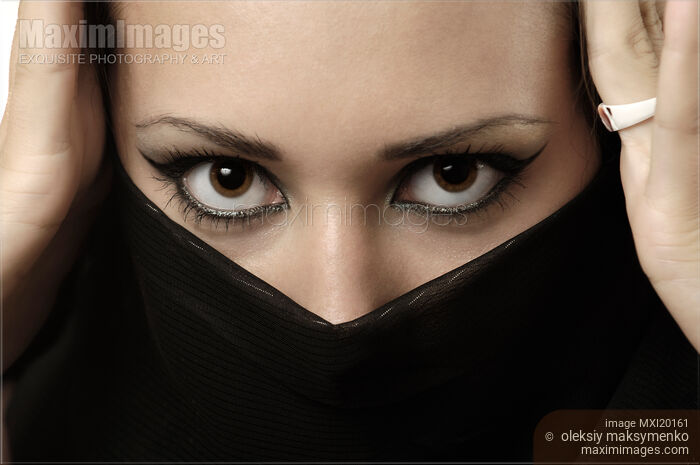 Stock photo of Woman with Beautiful Expressive Eyes Covering Face with Scarf Buy commercial use license at MaximImages