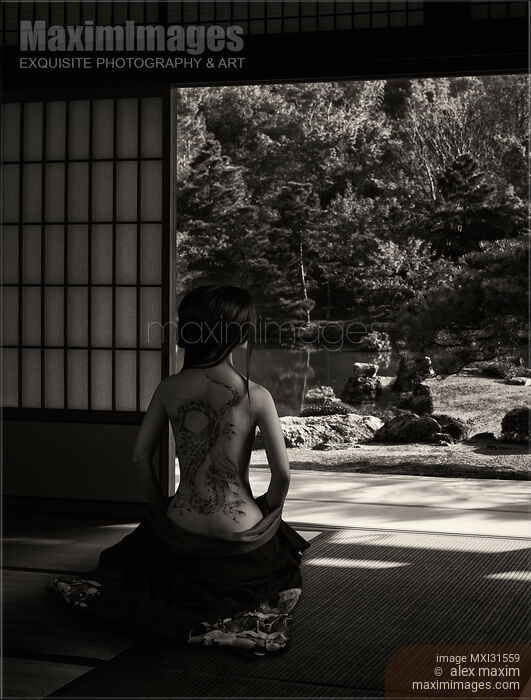 Stock photo of Woman with her kimono lowered revealing her naked back with a dragon tattoo sitting in a Japanese house Buy commercial use license at MaximImages