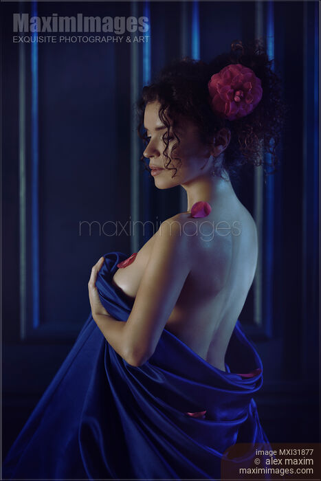 Woman with pink camellia flower in her hair covering her naked body with a bed sheet Stock photo of Woman with pink camellia flower in her hair covering her naked body with a bed sheet Buy commercial use license at MaximImages