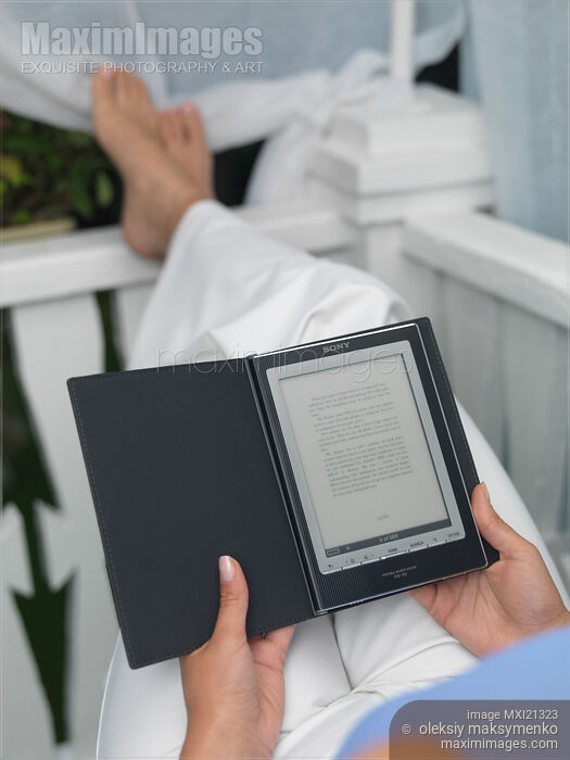 Stock photo of Woman with Sony Reader Buy commercial use license at MaximImages