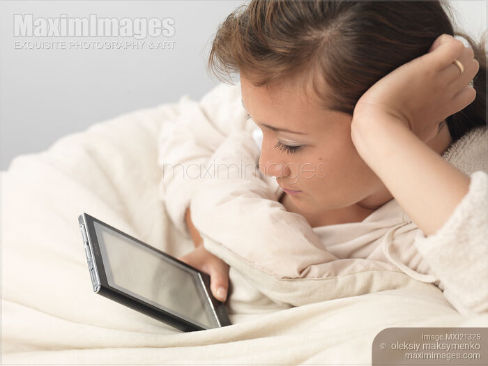 Stock photo of Woman with Sony Reader Buy commercial use license at MaximImages