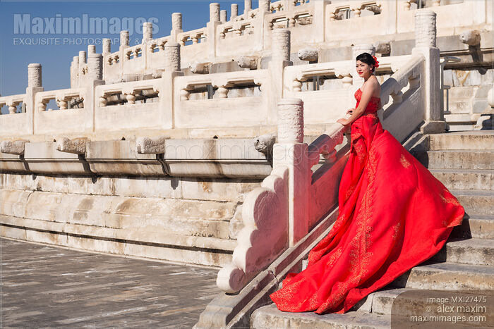 Stock photo of Young bride in red dress in China Buy commercial use license at MaximImages
