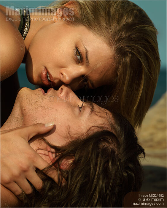 Young couple kissing at the beach Stock photo of Young couple kissing at the beach Buy commercial use license at MaximImages