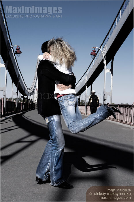 Young Couple Kissing on the Bridge Stock photo of Young Couple Kissing on the Bridge Buy commercial use license at MaximImages