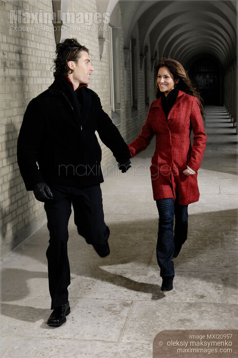 Stock photo of Young Couple Running Together Buy commercial use license at MaximImages